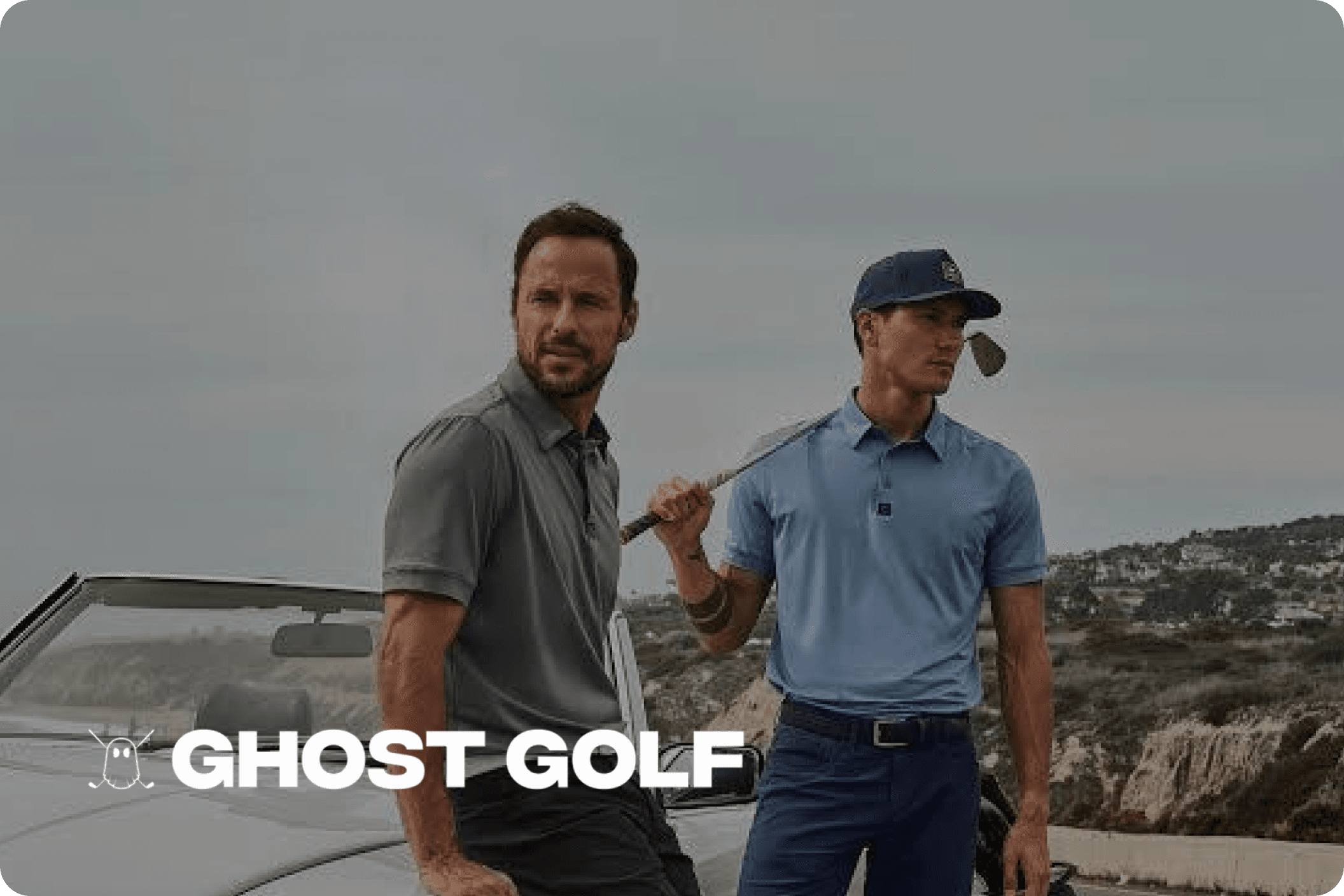 A Ghost Golf towel on the floor of a driving range